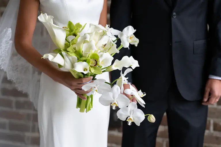 The bride's white bouquet as she stands beside her groom
