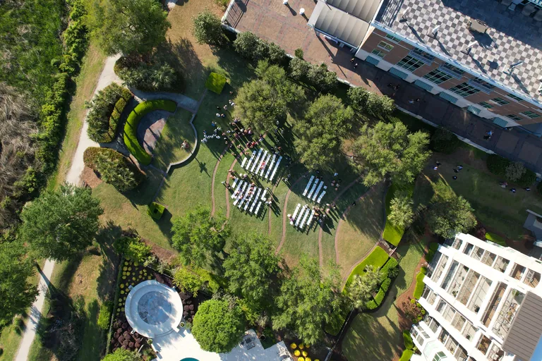Aerial view of a wedding reception laid out among the trees