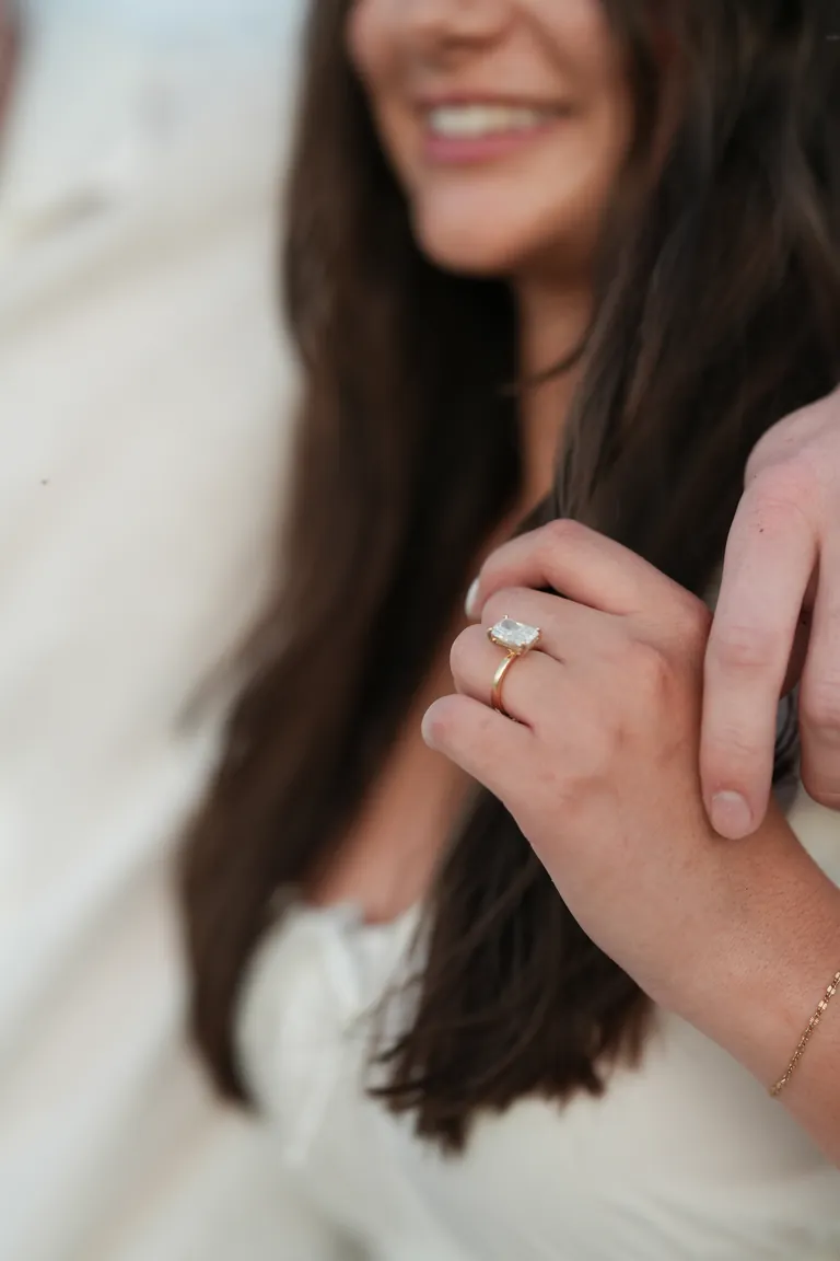 A close-up of an engagement ring on the bride's hand
