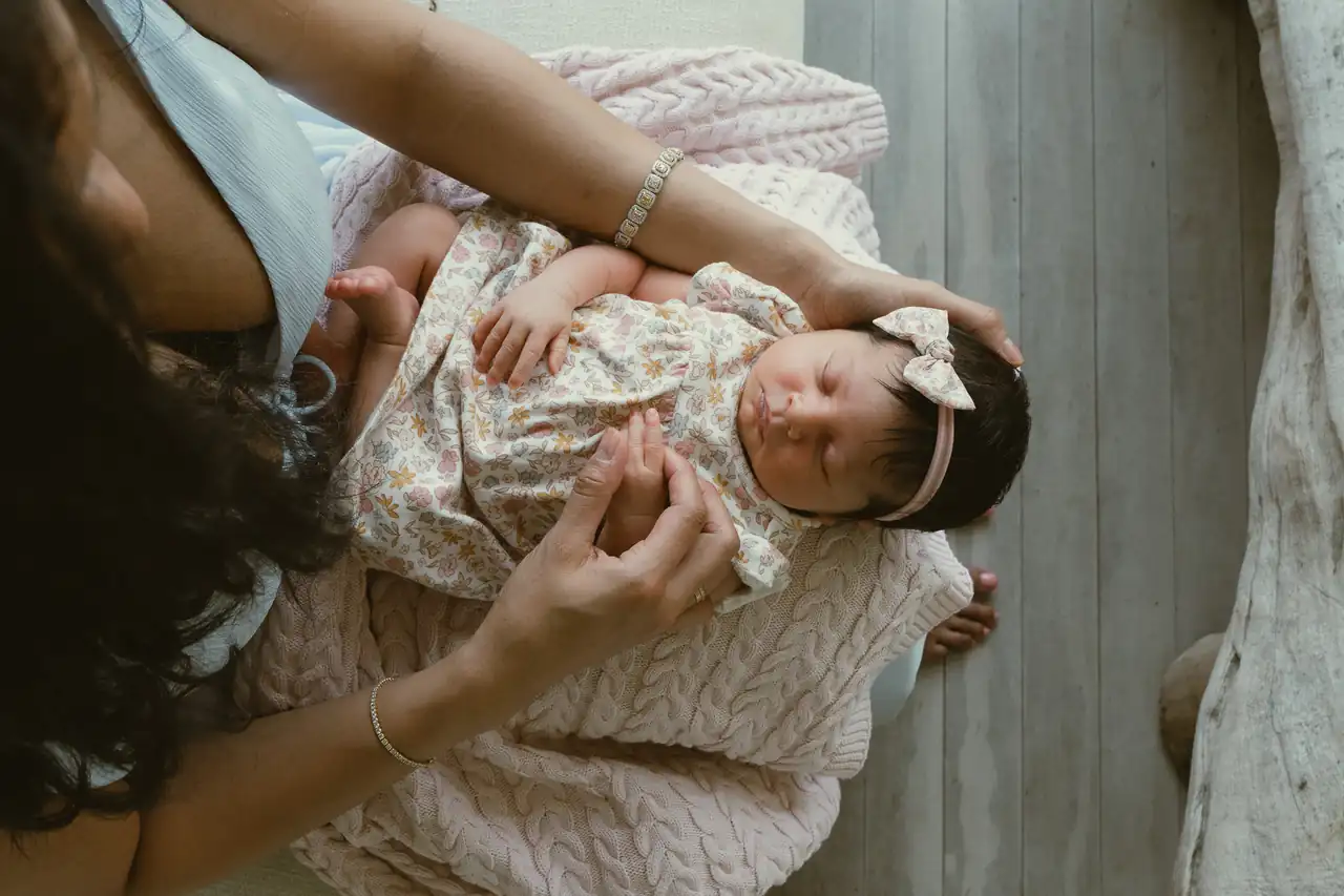 A mother holding her newborn during a family portrait session